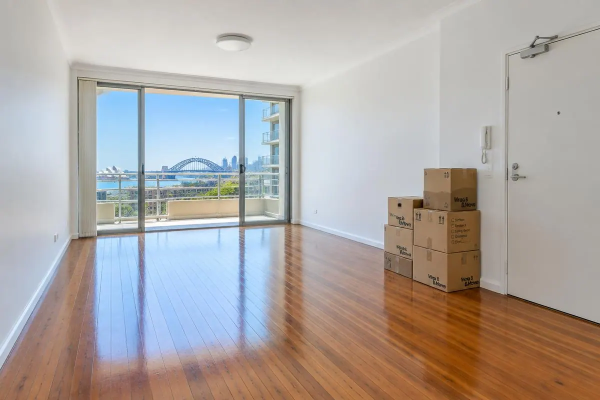 Empty Sydney apartment with moving boxes and polished timber floors at the end of a lease