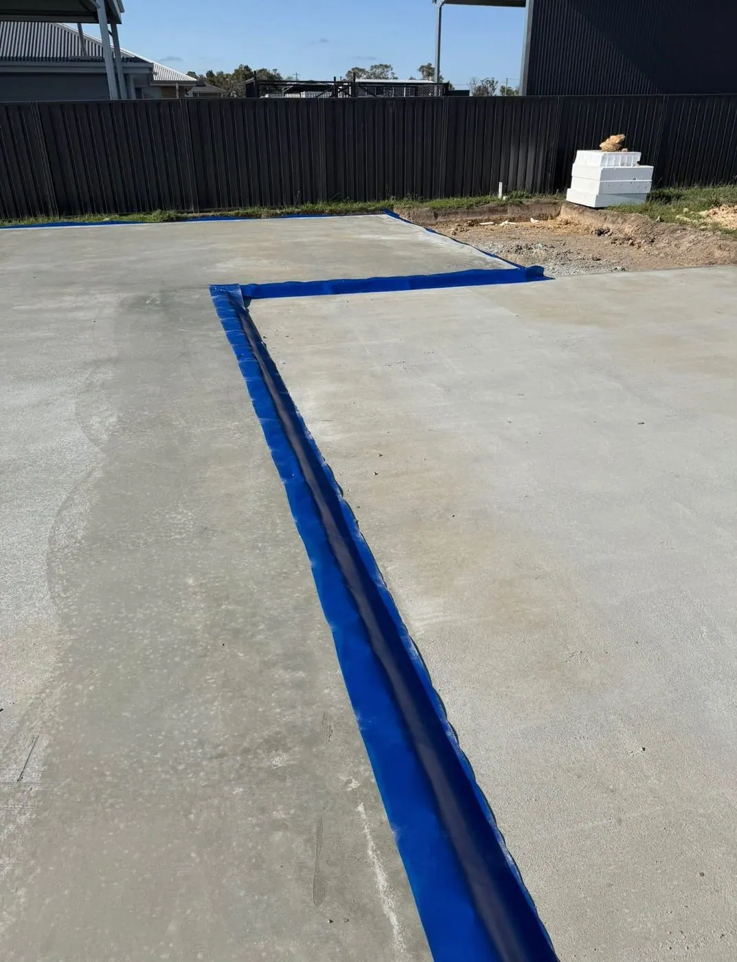 Termite barrier sheeting fitted along the edge of a new concrete slab